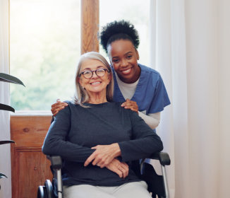 Nurse and woman with wheelchair, portrait and smile in health at nursing home.