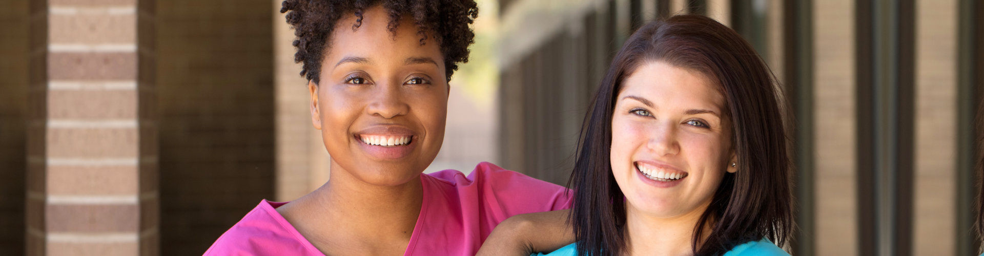 two female caregivers smiling