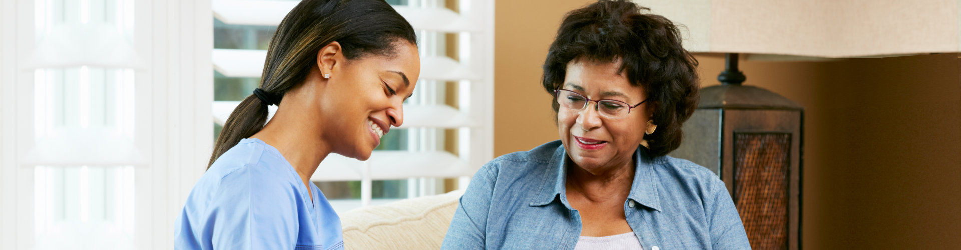 nurse and elderly woman talking