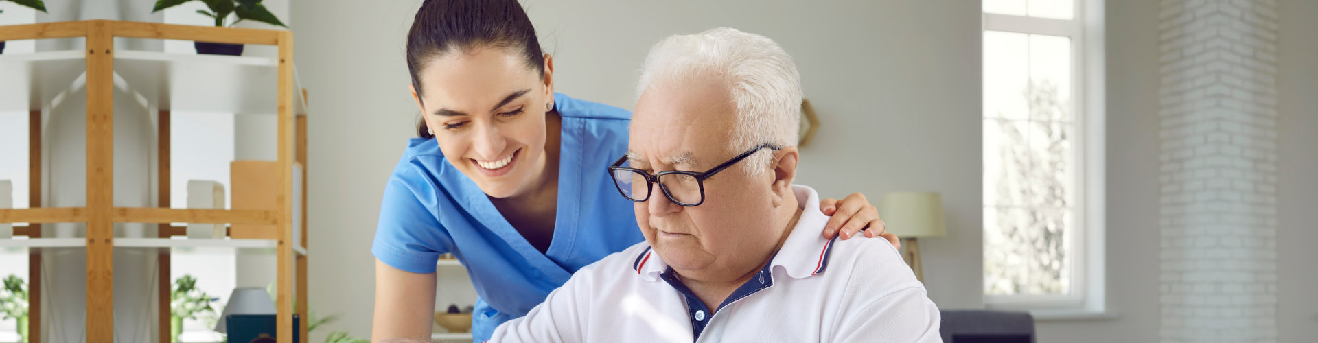 nurse assisting elderly man