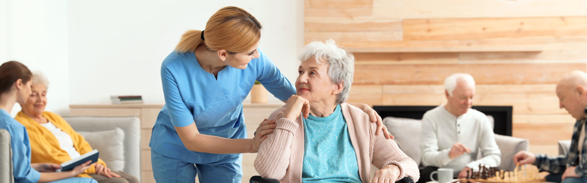 a caregiver and an elderly woman both smiling